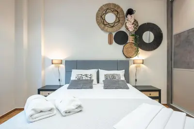 a bedroom with a white bed with towels on it at Exclusive Mavili Suite by CloudKeys in Athens