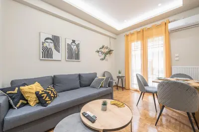 a living room with a couch and a table at Exclusive Mavili Suite by CloudKeys in Athens