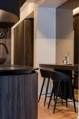 a kitchen with a bar with two stools at Bullet Athens in Athens