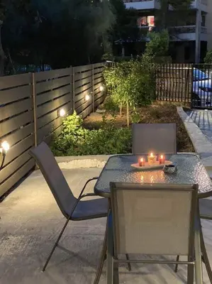 a patio with a table and two chairs with candles on it at D & A house 150m from Chalandri metro station in Athens