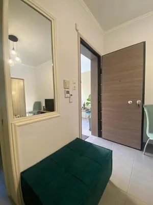 a room with a green bench in front of a door at D & A house 150m from Chalandri metro station in Athens