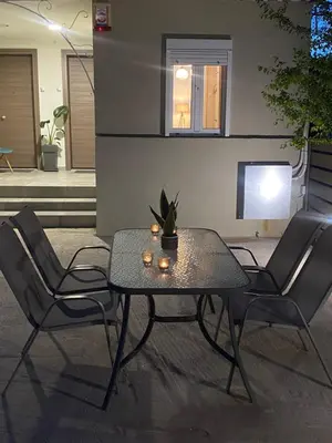 a table and chairs in a living room with a tv at D & A house 150m from Chalandri metro station in Athens