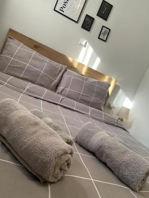 a bedroom with a bed with a headboard and pillows at D & A house 150m from Chalandri metro station in Athens