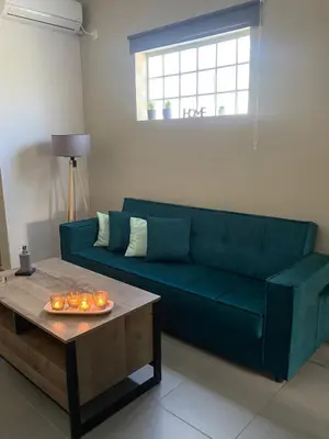 a living room with a blue couch and a coffee table at D & A house 150m from Chalandri metro station in Athens