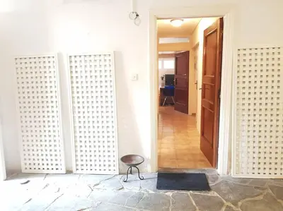 a hallway with a door and a stool in a room at Beautiful Studio at Glyfada in Athens