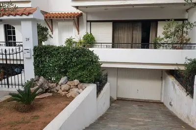 a white house with a porch and a balcony at Beautiful Studio at Glyfada in Athens