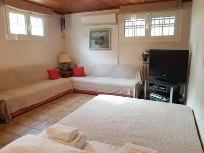 a living room with a couch and a tv at Beautiful Studio at Glyfada in Athens
