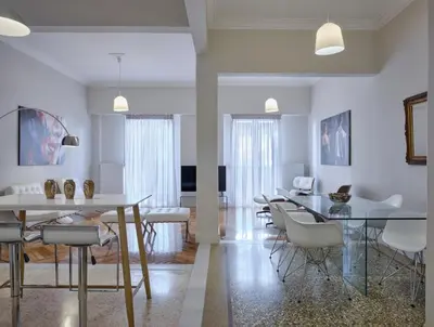 a living room with a dining room table and chairs at Quiet, central 2bd Apt, Kolonaki in Athens