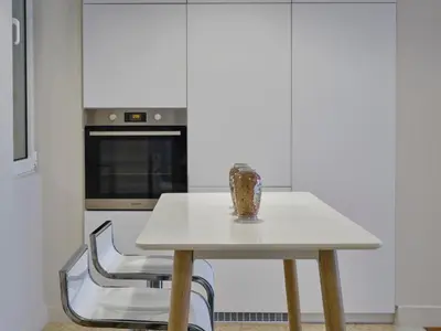 a white table with a vase on it in a kitchen at Quiet, central 2bd Apt, Kolonaki in Athens