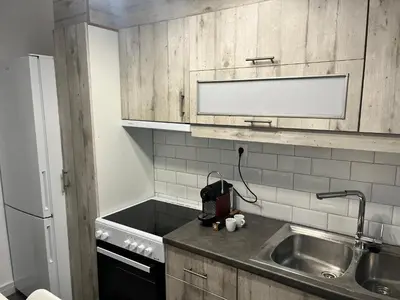 a small kitchen with a sink and a refrigerator at Metropolitan Complex Apartment-next to Metropolitan Hospital,Karaiskaki,Sef in Piraeus