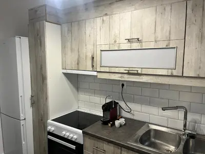 a small kitchen with a sink and a refrigerator at Metropolitan Complex Apartment-next to Metropolitan Hospital,Karaiskaki,Sef in Piraeus
