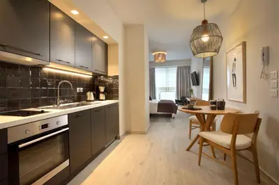 a kitchen with a table and a dining room at Happiness Luxury Central Apartment in Athens