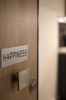 a door with a sign that says happiness on it at Happiness Luxury Central Apartment in Athens