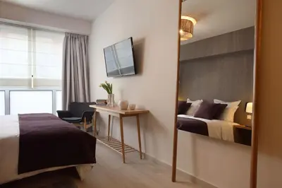 a hotel room with a bed and a desk at Happiness Luxury Central Apartment in Athens