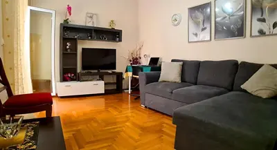 a living room with a couch and a television at Apartment in Athens, Kallithea in Athens