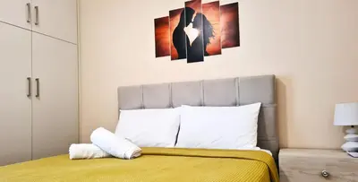 a bedroom with a bed with a yellow bedspread at Apartment in Athens, Kallithea in Athens