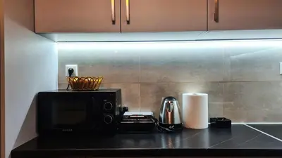 a kitchen counter with a microwave and a toaster at Apartment in Athens, Kallithea in Athens