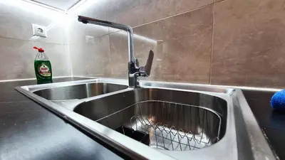 a stainless steel kitchen sink with a faucet at Apartment in Athens, Kallithea in Athens