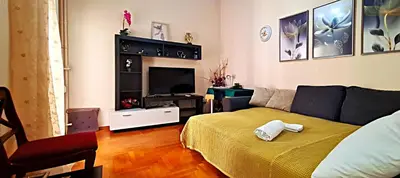 a living room with a couch and a television at Apartment in Athens, Kallithea in Athens