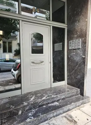 a white door on the side of a building at Apartment in Athens, Kallithea in Athens