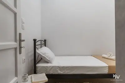 a small bed in a room with a window at Modern and Cozy apartment in the heart of Athens in Athens