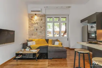 a living room with a couch and a table at Modern and Cozy apartment in the heart of Athens in Athens