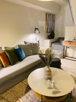 a living room with a couch and a table at Luxury Maisonette with Shared Pool in Athens