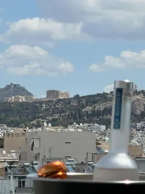 a view of a city from a window with a toothbrush at Luxury Maisonette with Shared Pool in Athens