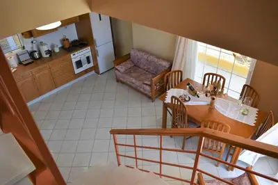 a kitchen and dining room with a table and chairs at Summer Villa , Kaki Thalassa in Dhaskalión