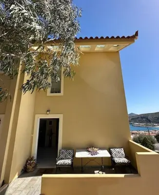a table and chairs sitting outside of a house at Summer Villa , Kaki Thalassa in Dhaskalión