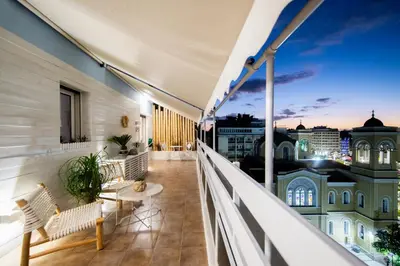 a balcony with a view of the city at night at Piraeus Urban Gem in Piraeus