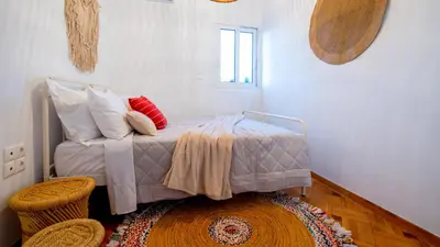 a bedroom with a bed with pillows on it at Piraeus Urban Gem in Piraeus