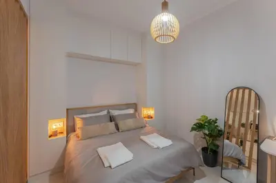 a bedroom with a large bed with two pillows on it at JV Luxury Apartment Acropolis in Athens