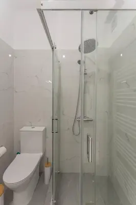 a bathroom with a glass shower and a toilet at JV Luxury Apartment Acropolis in Athens