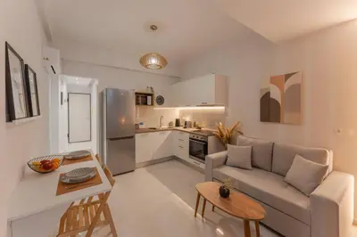 a living room with a couch and a kitchen at JV Luxury Apartment Acropolis in Athens