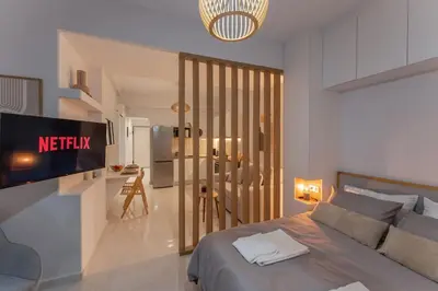 a bedroom with a bed and a tv in a room at JV Luxury Apartment Acropolis in Athens