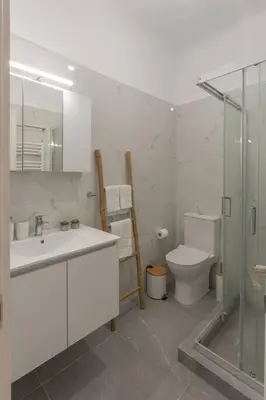 a bathroom with a toilet and a sink and a shower at JV Luxury Apartment Acropolis in Athens