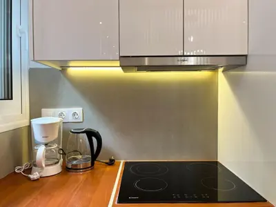 a kitchen with a stove top and a microwave at Cozy studio near Flisvos Marina in Athens