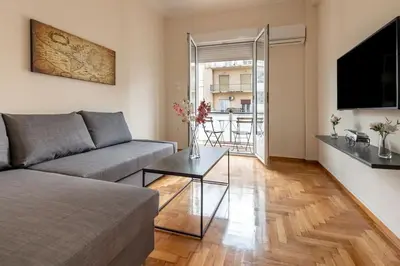a living room with a couch and a table at kerameikos 2 bedroom apartment in Athens