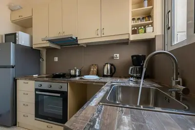 a kitchen with a sink and a stove at kerameikos 2 bedroom apartment in Athens