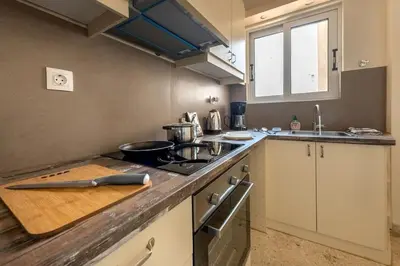 a kitchen with a wooden cutting board on a counter at kerameikos 2 bedroom apartment in Athens
