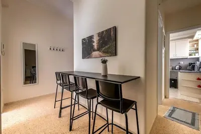 a black table and chairs in a room with a kitchen at kerameikos 2 bedroom apartment in Athens