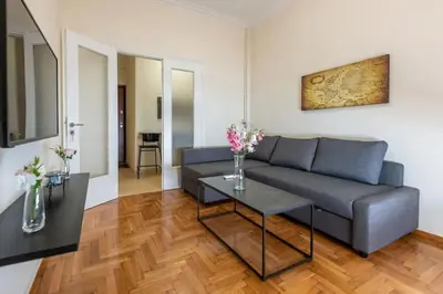 a living room with a couch and a table at kerameikos 2 bedroom apartment in Athens