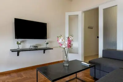 a living room with a vase of flowers on a table at kerameikos 2 bedroom apartment in Athens