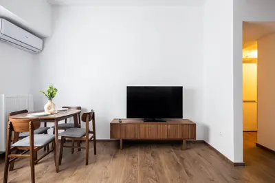 a living room with a table and a television at Alex 2 Bedroom Apartment in Athens in Athens
