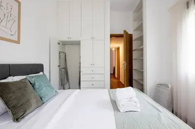 a bedroom with a white bed and a closet at Alex 2 Bedroom Apartment in Athens in Athens