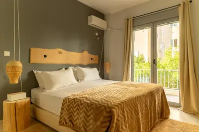 a bedroom with a bed and a large window at Eclipse Riviera Cinema in Athens