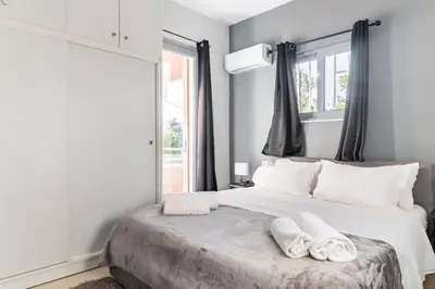 a bedroom with a bed with towels on it at Eclipse Riviera Cinema in Athens