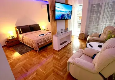 a bedroom with a bed and a flat screen tv at Sea View Studio in Athens