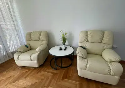 two chairs and a table in a room at Sea View Studio in Athens